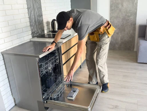 Technician checking an open residential dishwasher