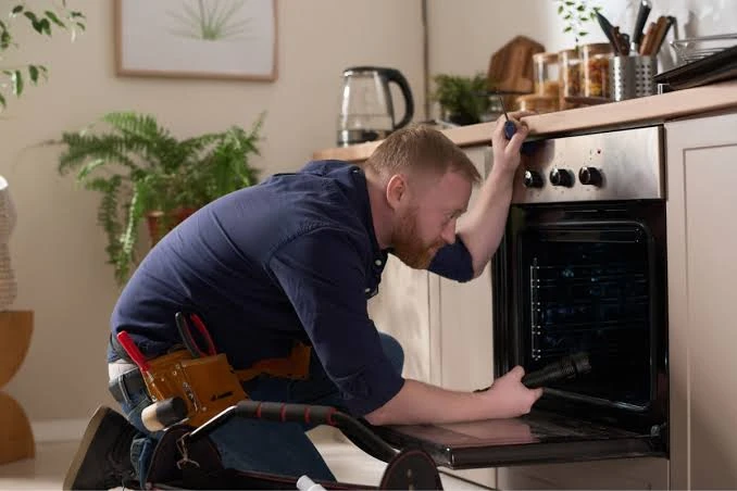 Technician working inside a residential oven